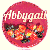 Beautifully decorated red velvet berry birthday cake with vibrant fruits and a glowing 'Abbygail' name, adding a touch of sweetness and sparkle.