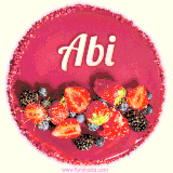 Beautifully decorated red velvet berry birthday cake with vibrant fruits and a glowing 'Abi' name, adding a touch of sweetness and sparkle.