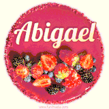 Beautifully decorated red velvet berry birthday cake with vibrant fruits and a glowing 'Abigael' name, adding a touch of sweetness and sparkle.