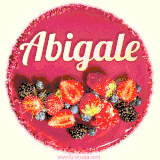 Beautifully decorated red velvet berry birthday cake with vibrant fruits and a glowing 'Abigale' name, adding a touch of sweetness and sparkle.