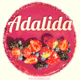 Beautifully decorated red velvet berry birthday cake with vibrant fruits and a glowing 'Adalida' name, adding a touch of sweetness and sparkle.