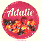 Beautifully decorated red velvet berry birthday cake with vibrant fruits and a glowing 'Adalie' name, adding a touch of sweetness and sparkle.