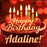 Beautifully decorated red velvet berry birthday cake with vibrant fruits and a glowing 'Adaline' name, adding a touch of sweetness and sparkle.
