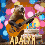 Animated birthday GIF showing a capybara playing guitar and singing beside a birthday cake with the name Adalyn in large letters and colorful bokeh lights in the background.