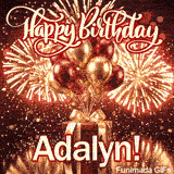 Close-up of a luxurious red gift box with a wide golden ribbon and metallic balloons around the base of the fireworks and name Adalyn