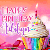 A vibrant birthday GIF featuring a rainbow-colored cupcake topped with white frosting, sprinkles, and a lit candle. The text reads 'Happy Birthday Adilyn' in bold pink and violet letters with white outline.