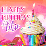 A vibrant birthday GIF featuring a rainbow-colored cupcake topped with white frosting, sprinkles, and a lit candle. The text reads 'Happy Birthday Ailie' in bold pink and violet letters with white outline.
