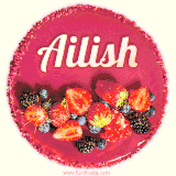 Beautifully decorated red velvet berry birthday cake with vibrant fruits and a glowing 'Ailish' name, adding a touch of sweetness and sparkle.