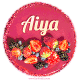Beautifully decorated red velvet berry birthday cake with vibrant fruits and a glowing 'Aiya' name, adding a touch of sweetness and sparkle.