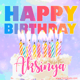 A vibrant animated name GIF with the words 'Happy Birthday Aksinya' with colorful candles on a creamy cake. The background sparkles with pastel shades, adding a festive touch.