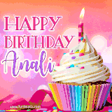 A vibrant birthday GIF featuring a rainbow-colored cupcake topped with white frosting, sprinkles, and a lit candle. The text reads 'Happy Birthday Anali' in bold pink and violet letters with white outline.