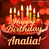 Beautifully decorated red velvet berry birthday cake with vibrant fruits and a glowing 'Analia' name, adding a touch of sweetness and sparkle.