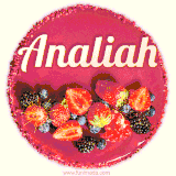 Beautifully decorated red velvet berry birthday cake with vibrant fruits and a glowing 'Analiah' name, adding a touch of sweetness and sparkle.