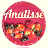 Beautifully decorated red velvet berry birthday cake with vibrant fruits and a glowing 'Analisse' name, adding a touch of sweetness and sparkle.