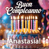 Birthday cake topped with pink and yellow lit candles, surrounded by glowing bokeh lights and party balloons. The greeting 'Buon Compleanno Anastasia GIF!' is displayed.