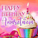 A vibrant birthday GIF featuring a rainbow-colored cupcake topped with white frosting, sprinkles, and a lit candle. The text reads 'Happy Birthday Anasztázia' in bold pink and violet letters with white outline.