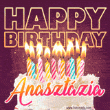 A colorful birthday cake topped with lit candles, with the words 'Happy Birthday Anasztázia' in bold glowing letters on a burgundy background. Animated flames add a festive touch.