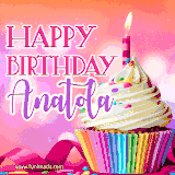 A vibrant birthday GIF featuring a rainbow-colored cupcake topped with white frosting, sprinkles, and a lit candle. The text reads 'Happy Birthday Anatola' in bold pink and violet letters with white outline.