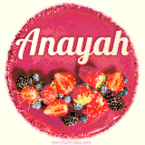 Beautifully decorated red velvet berry birthday cake with vibrant fruits and a glowing 'Anayah' name, adding a touch of sweetness and sparkle.
