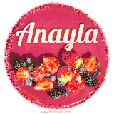 Beautifully decorated red velvet berry birthday cake with vibrant fruits and a glowing 'Anayla' name, adding a touch of sweetness and sparkle.