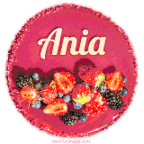 Beautifully decorated red velvet berry birthday cake with vibrant fruits and a glowing 'Ania' name, adding a touch of sweetness and sparkle.