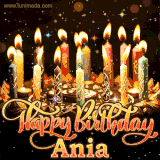 A glowing personalized birthday GIF with name Ania featuring lit candles with intricate designs, warm lighting, and the text 'Happy Birthday' in an elegant font.