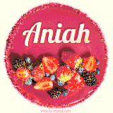 Beautifully decorated red velvet berry birthday cake with vibrant fruits and a glowing 'Aniah' name, adding a touch of sweetness and sparkle.