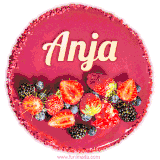 Beautifully decorated red velvet berry birthday cake with vibrant fruits and a glowing 'Anja' name, adding a touch of sweetness and sparkle.