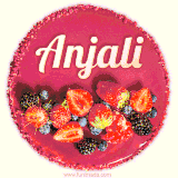 Beautifully decorated red velvet berry birthday cake with vibrant fruits and a glowing 'Anjali' name, adding a touch of sweetness and sparkle.