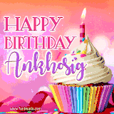 A vibrant birthday GIF featuring a rainbow-colored cupcake topped with white frosting, sprinkles, and a lit candle. The text reads 'Happy Birthday Ankhosig' in bold pink and violet letters with white outline.