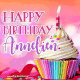 A vibrant birthday GIF featuring a rainbow-colored cupcake topped with white frosting, sprinkles, and a lit candle. The text reads 'Happy Birthday Annelien' in bold pink and violet letters with white outline.