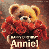 Cinematic style cute animated teddy bear with charming features holding a large bouquet of red roses, the words say 'Happy Birthday Annie' in sans serif font.