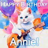 Animated GIF featuring a charming white cat with bright blue eyes strumming a guitar while colorful balloons float in the background, with 'Happy Birthday Annie!' text.
