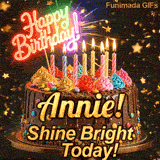Bold golden lettering spelling Annie! on a gourmet chocolate cake with the subtext Shine Bright Today! on a gold stand.