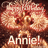 Large white nameplate spelling Annie with red outline placed on a luxurious red gift box under party balloons.