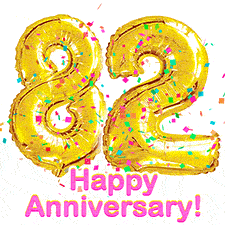 Sparkling gold balloons forming the number 82 with a burst of multicolored confetti and vibrant pink 'Happy Anniversary' text.