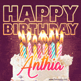 A colorful birthday cake topped with lit candles, with the words 'Happy Birthday Anthia' in bold glowing letters on a burgundy background. Animated flames add a festive touch.