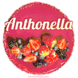 Beautifully decorated red velvet berry birthday cake with vibrant fruits and a glowing 'Anthonella' name, adding a touch of sweetness and sparkle.