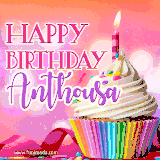 A vibrant birthday GIF featuring a rainbow-colored cupcake topped with white frosting, sprinkles, and a lit candle. The text reads 'Happy Birthday Anthousa' in bold pink and violet letters with white outline.