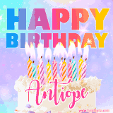 A vibrant animated name GIF with the words 'Happy Birthday Antiope' with colorful candles on a creamy cake. The background sparkles with pastel shades, adding a festive touch.