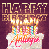 A colorful birthday cake topped with lit candles, with the words 'Happy Birthday Antiope' in bold glowing letters on a burgundy background. Animated flames add a festive touch.