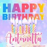 A vibrant animated name GIF with the words 'Happy Birthday Antoinetta' with colorful candles on a creamy cake. The background sparkles with pastel shades, adding a festive touch.