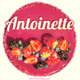 Beautifully decorated red velvet berry birthday cake with vibrant fruits and a glowing 'Antoinette' name, adding a touch of sweetness and sparkle.