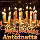 A glowing personalized birthday GIF with name Antoinette featuring lit candles with intricate designs, warm lighting, and the text 'Happy Birthday' in an elegant font.