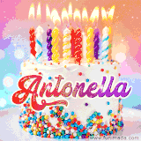 A cheerful white birthday cake with multicolor sprinkles, lit candles, and 'Antonella' written in vibrant letters, in an animated GIF.