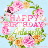A charming animated GIF featuring 'Happy Birthday Antonetta' in pink and green text, surrounded by delicate roses, leaves, and fluttering butterflies on a soft light blue pastel background.