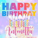 A vibrant animated name GIF with the words 'Happy Birthday Antonetta' with colorful candles on a creamy cake. The background sparkles with pastel shades, adding a festive touch.