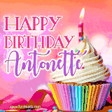 A vibrant birthday GIF featuring a rainbow-colored cupcake topped with white frosting, sprinkles, and a lit candle. The text reads 'Happy Birthday Antonette' in bold pink and violet letters with white outline.