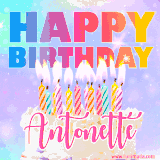 A vibrant animated name GIF with the words 'Happy Birthday Antonette' with colorful candles on a creamy cake. The background sparkles with pastel shades, adding a festive touch.