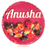 Beautifully decorated red velvet berry birthday cake with vibrant fruits and a glowing 'Anusha' name, adding a touch of sweetness and sparkle.